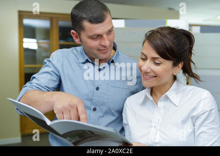 man and woman working with documents at table in archive Stock Photo