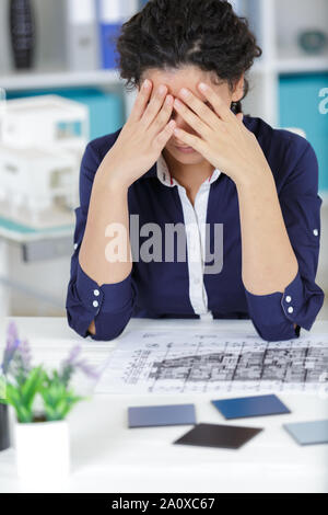 female architect stressed and under pressure in the office Stock Photo