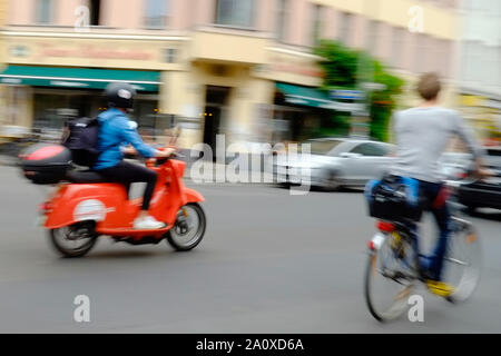 Berlin, Germany. 11th July, 2019. A young man drives with an electric scooter of the lender Emmy over the Heinrichplatz in the district Kreuzberg. Credit: Stefan Jaitner/dpa/Alamy Live News Stock Photo