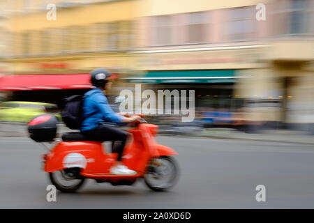 Berlin, Germany. 11th July, 2019. A young man drives with an electric scooter of the lender Emmy over the Heinrichplatz in the district Kreuzberg. Credit: Stefan Jaitner/dpa/Alamy Live News Stock Photo