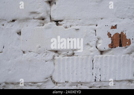 Brick white wall. Red brick is painted white with whitewash. Corner of a clouded wall. The old wall. Invoice for designers. Brickwork in the daylight. Stock Photo