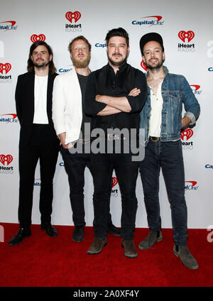 Marcus Mumford, Ben Lovett and Ted Dwane of Mumford & Sons walking on