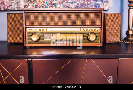 Old retro radio receiver on wooden table. Old-fashioned device. Stock Photo