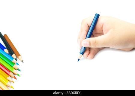 Women hand with pencil by hand on  white  paper at white background, lady is holding a crayon in his hands at paper and crayons for drawing Stock Photo