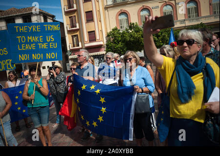 Anti-brexit demonstrators with flags and placards during the protest.A group of British people living in Malaga demand to protect the rights that UK Nationals living in Spain currently hold and show support to their Spanish friends who live in the UK, by protesting against the UK leaving Europe. Stock Photo