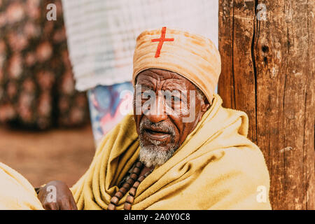 BAHIR DAR, ETHIOPIA, APRIL 21th. 2019, Old orthodox Christian monk resting on the street oif Bahir Dar during Easter holiday. April 21th. 2019, Bahir Stock Photo