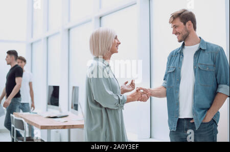 two designers discuss sketches standing in a spacious office Stock Photo
