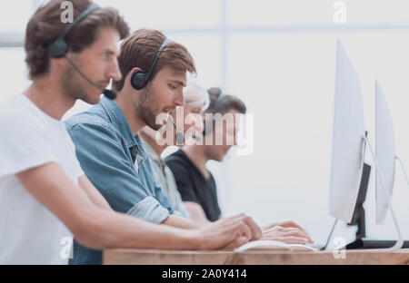 group of people in the headset works on personal computers. Stock Photo