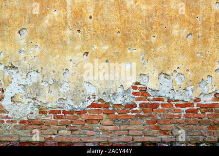 cracked plaster layer on old house, damage due to dampness Stock Photo