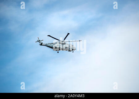 Military helicopter taking part in an exercise in the skies above Cornwall, England, UK Stock Photo
