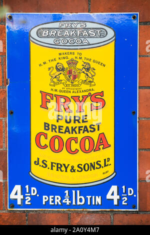 Old advertising sign on the wall of a platform at Toddington heritage railway station in the Cotswolds, England UK Stock Photo