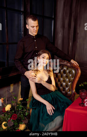 Happy Halloween. Attractive young woman and man preparing for Halloween by setting the table for a festive dinner. Stock Photo