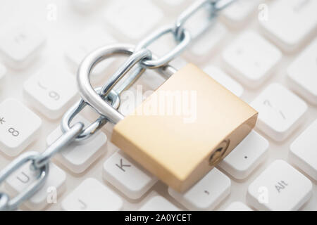 Security concept with metal padlock and chain on computer keyboard Stock Photo