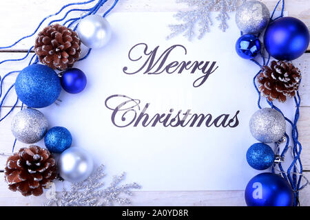 Text merry christmas on paper with many balls Stock Photo