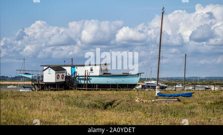 WEST MERSEA, ESSEX, UK - AUGUST 31, 2018:  Houseboats moored on the River Blackwater Stock Photo