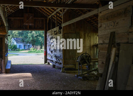 Farm tools hanging on the wall of an old Blacksmith shop preserved at Kleb Woods Nature Park. Houston, Texas, USA. Stock Photo