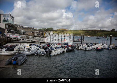 Whitestrand Pontoon in Salcombe Devon, covered with small rubber boats moored up whilst people visit the town. Salcombe, Devon Stock Photo