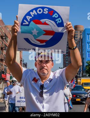 New York, USA. 22nd Sep, 2019. Hundreds Puerto Ricans dressed in white participated on a silent procession carrying signs and banners through the streets of New York on September 22, 2019 to focus the nation's attention on this callous and craven neglect of U.S. Citizens in Puerto Rico still struggling for survival in the aftermath of Hurricane Maria. Credit: Erik McGregor/ZUMA Wire/Alamy Live News Stock Photo