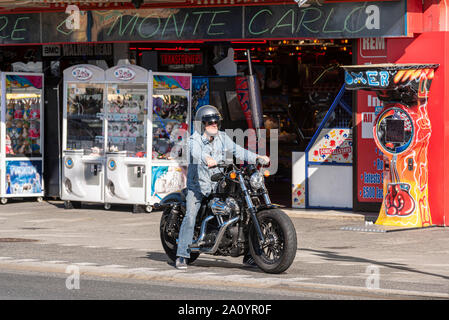 Harley Davidson rider outside Monte Carlo amusement arcade on Marine Parade, Southend on Sea, Essex, UK. Stock Photo