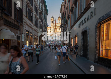 Tourists on Via dei Condotti looking at Piazza dl Spagna and the Spanish Steps, Rome, Italy Stock Photo