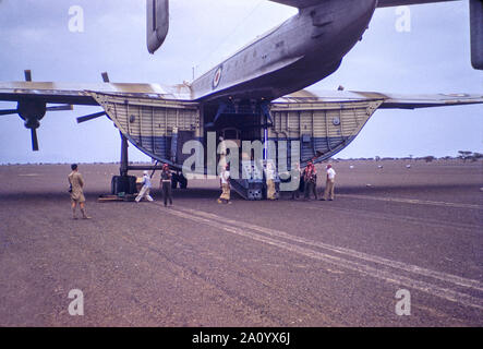 Freight being off loaded from a Beverley heavy transport aircraft operated by the Royal Air force Transport Command at RAF Sharjah in the UAE in 1962. Stock Photo