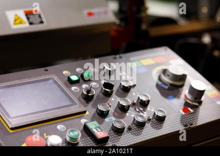 Industrial machine remote control panel with buttons, switches and touch screen. Selective focus. Stock Photo