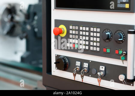 Modern turning machine with CNC control panel in the foreground. Selective focus. Stock Photo