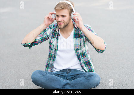 Online learning. Educational technology. E learning. Study anywhere. Audio book concept. Worldwide knowledge access. Audio library. Another way of learning. Man handsome college student headphones. Stock Photo