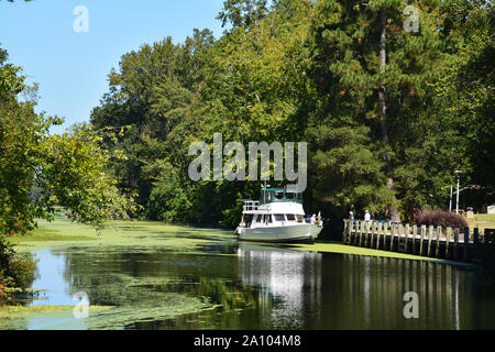 A boat travels south on the Intracoastal Waterway through the Great Dismal Swamp State Park outside of Camden North Carolina.