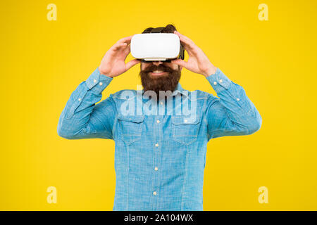 Impressive visual effects. Cyber sport. Augmented reality. Game development. Digital technology. Living alternative life. Hipster play video game. Bearded man explore vr. Gamer concept. Gaming hobby. Stock Photo