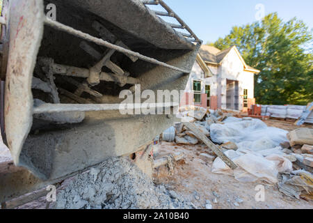 Close-up of cement mixer used when laying bricks during new home construction. Stock Photo