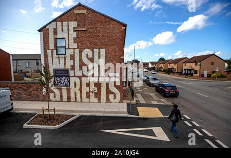 A mural with the wording 'The Welsh Streets' painted on the side of a house in Liverpool. The streets of the city have been transformed with bursts of colour as artists make their mark. Stock Photo