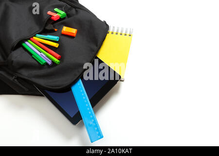 Back to school concept. Backpack with school supplies and tablet Stock Photo