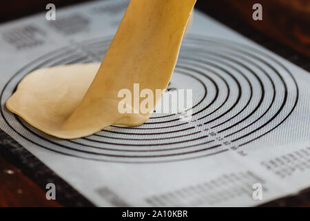 the puff pastry on a silicone Mat for dough Stock Photo