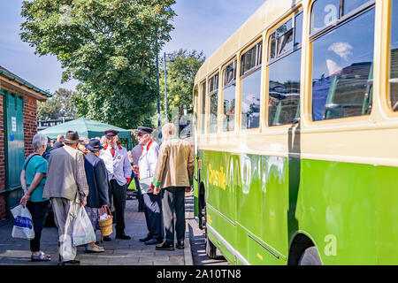 group of people in 1940s dress queuing for a classic forties bus during the annual forties weekend in Sheringham Stock Photo