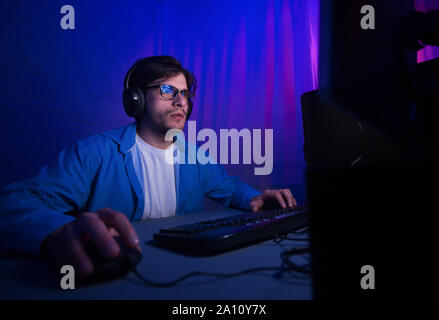 Professional gamer playing in first-person shooter video game Stock Photo