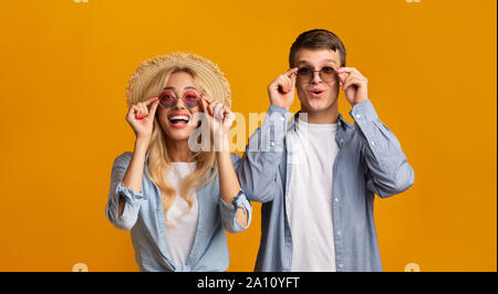 Young couple trying on trendy sunglasses, getting ready for vacation Stock Photo