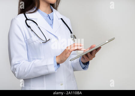 Unrecognizable Doctor Using Digital Tablet On White Stock Photo