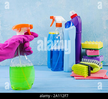 Cleaning service concept. Colorful cleaning set for different surfaces in kitchen, bathroom and other rooms. Stock Photo