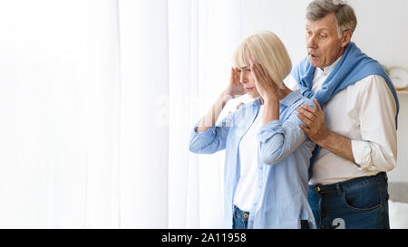 Consoling senior woman after argument, offended wife Stock Photo