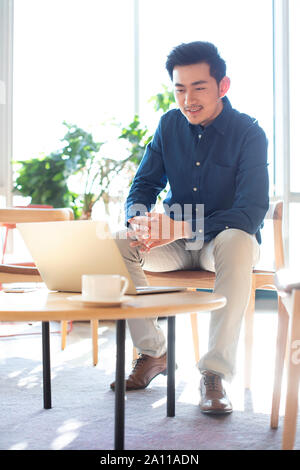 Young man using laptop Stock Photo