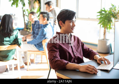 Young abroad student using computer Stock Photo