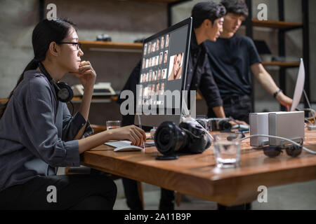 Photographers working in studio Stock Photo