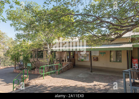 KRUGER NATIONAL PARK, SOUTH AFRICA - MAY 16, 2019: View of the reception office and store in Punda Maria Rest Camp. A zebra skin is visible Stock Photo