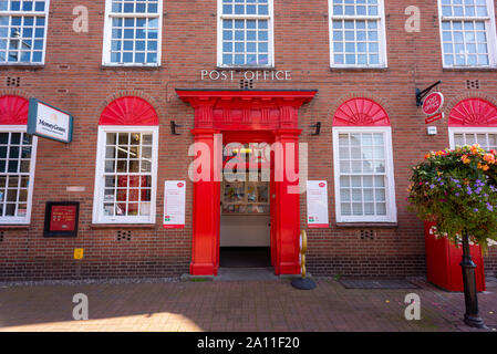 Red paint standing out on the facade of the Post Office building, Nantwich town centre, Cheshire, UK Stock Photo