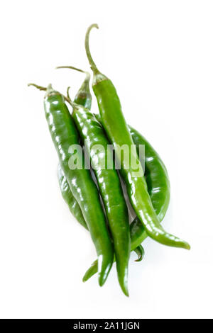 Green chillies on a wooden surface Stock Photo