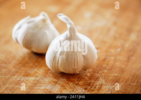 Garlic cloves, close up on a wooden surface Stock Photo
