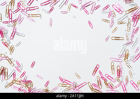 Pattern of multicolored paper clips on grey background. Back to school. Office, business, paperwork, education concept. Banner Stock Photo