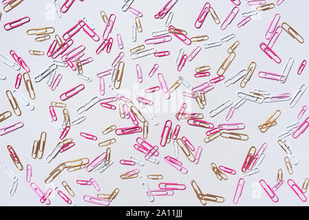 Pattern of multicolored paper clips on grey background. Back to school. Office, business, paperwork, education concept. Banner Stock Photo