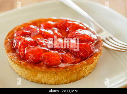 Strawberry tart on a plate with a fork Stock Photo